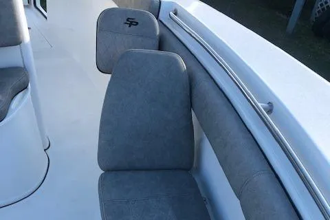 Slide: The Image of 2021 Sea Pro 259 DLX boat interior with gray cushioned seating. - 7
