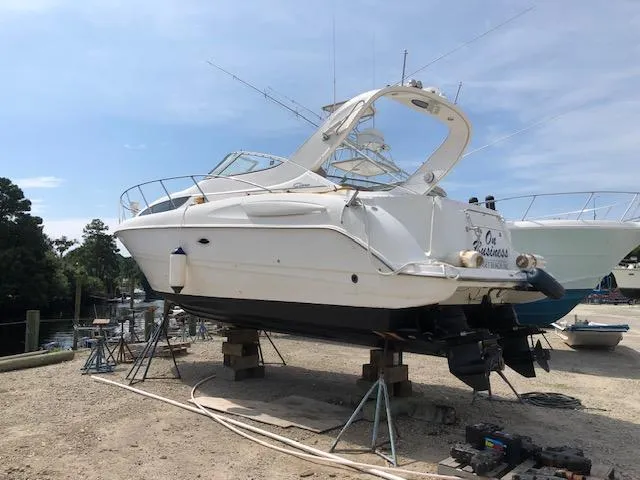 Slide: The Image of 2000 Bayliner 3055 Ciera boat on dry dock, undergoing maintenance. - 1