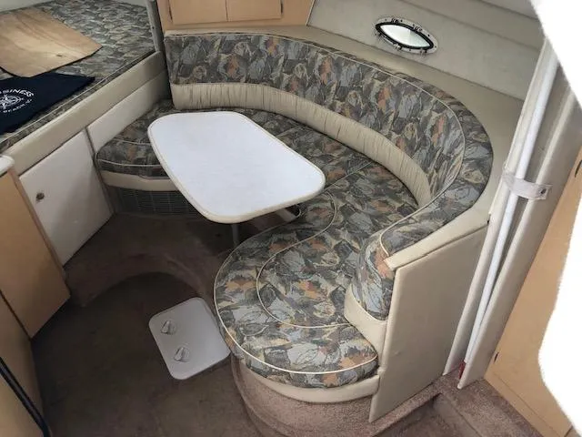 Slide: The Image of 2000 Bayliner 3055 Ciera interior with curved seating and table. - 21