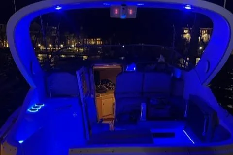 Slide: The Image of Bayliner 3055 Ciera 2000 model with blue LED lights at night. - 26