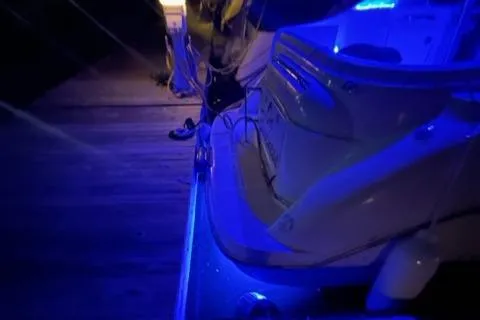 Slide: The Image of Bayliner 3055 Ciera 2000 model with blue LED lights at night. - 27