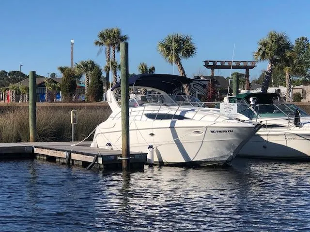 Slide: The Image of 2000 Bayliner 3055 Ciera docked at marina with palm trees in background. - 32