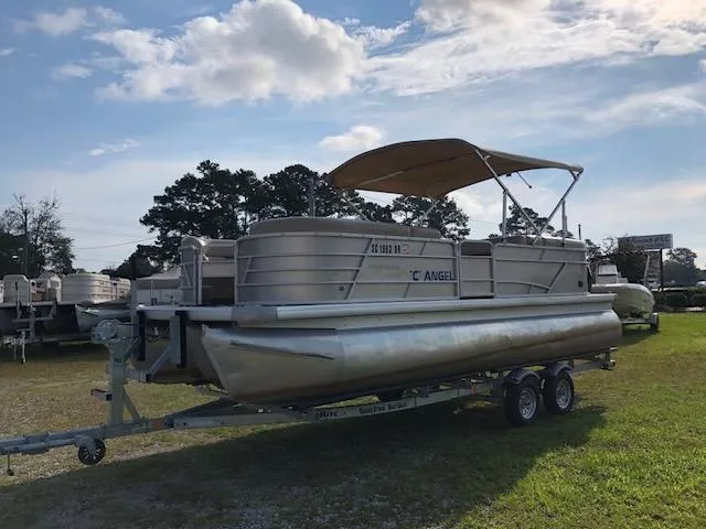 The Image of 2021 Sweetwater 2286 pontoon boat on trailer under a sunny sky. - 1