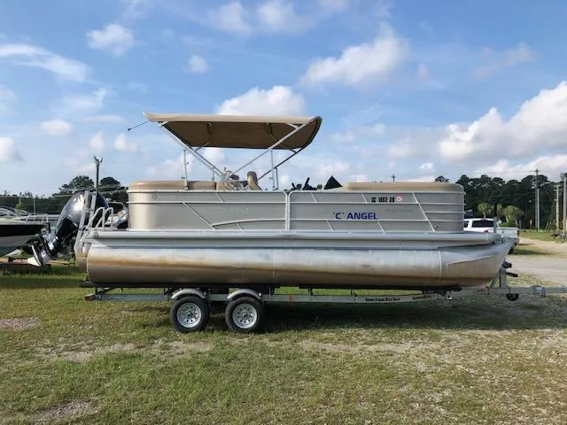 Slide: The Image of 2021 Sweetwater 2286 pontoon boat on trailer under blue sky. - 3