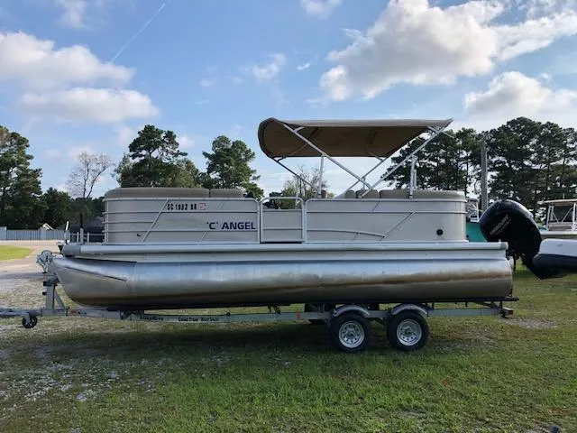 Slide: The Image of 2021 Sweetwater 2286 pontoon boat on trailer, parked on grass under cloudy sky. - 7