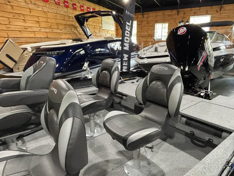 Slide: The Image of 2025 Lund 2025 Impact XS Sport boat interior with seating and motor display. - 10