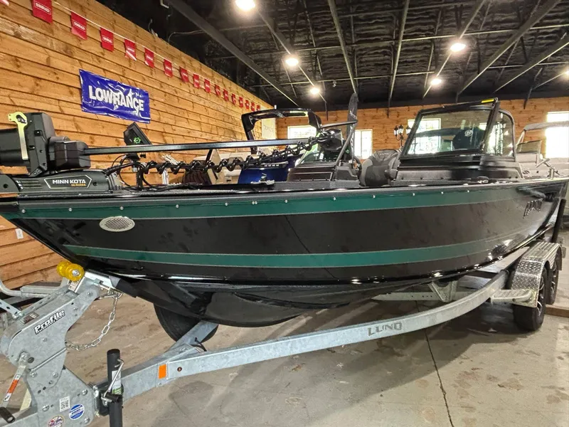 Slide: The Image of 2025 Lund 2025 Impact XS Sport boat on trailer in showroom setting. - 15