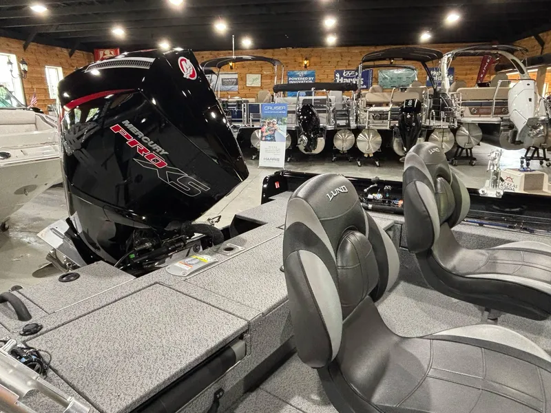 Slide: The Image of 2025 Lund 2025 Impact XS Sport boat interior with Pro XS engine in showroom. - 16
