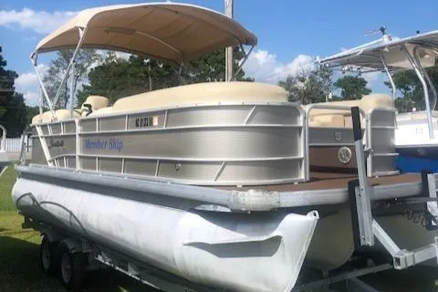 The Image of 2018 Godfrey Sweetwater 2286C pontoon boat on trailer with canopy, parked outdoors. - 1