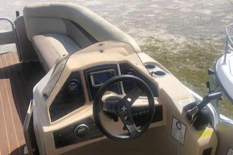 Slide: The Image of 2018 Godfrey Sweetwater 2286C boat interior with steering console and seating. - 10
