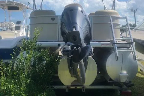 Slide: The Image of 2018 Godfrey Sweetwater 2286C pontoon boat with outboard motor, parked outdoors. - 3