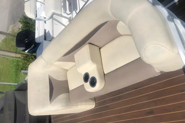 Slide: The Image of 2018 Godfrey Sweetwater 2286C boat seating with cup holders on wooden deck. - 6