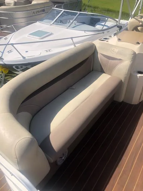Slide: The Image of 2018 Godfrey Sweetwater 2286C boat with beige seating and wooden deck. - 7
