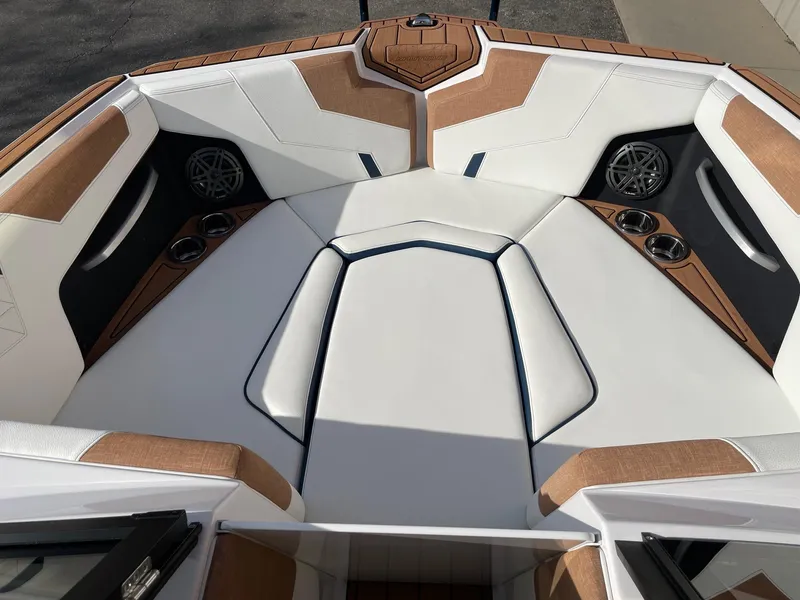 Slide: The Image of 2024 Nautique Super Air Nautique GS22 boat interior with white and tan seating. - 11