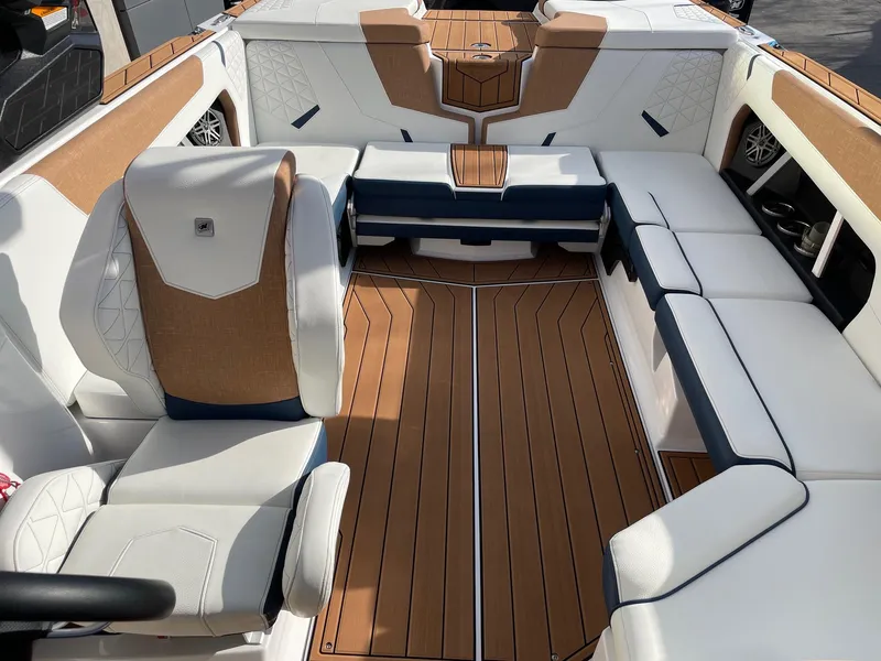 Slide: The Image of 2024 Nautique Super Air Nautique GS22 interior with luxurious seating and teak flooring. - 12