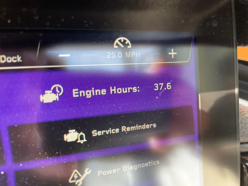 Slide: The Image of 2024 Nautique Super Air Nautique GS22 dashboard showing 37.6 engine hours and 25 MPH speed. - 13