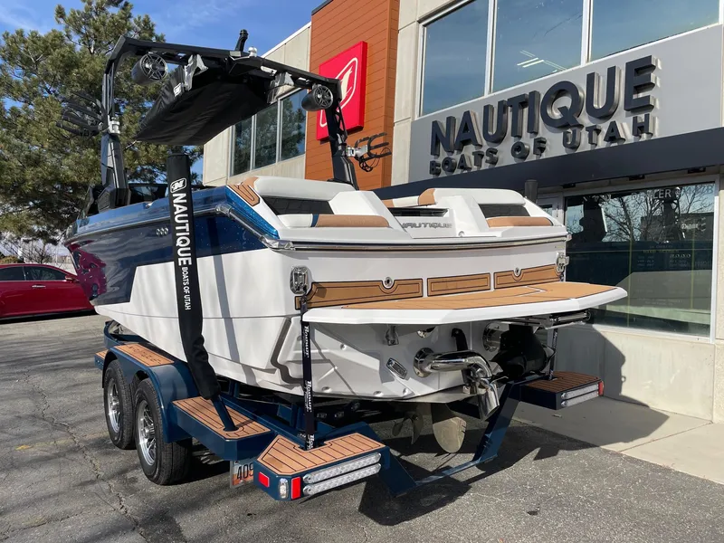Slide: The Image of 2024 Nautique Super Air Nautique GS22 boat at dealership, rear view. - 3