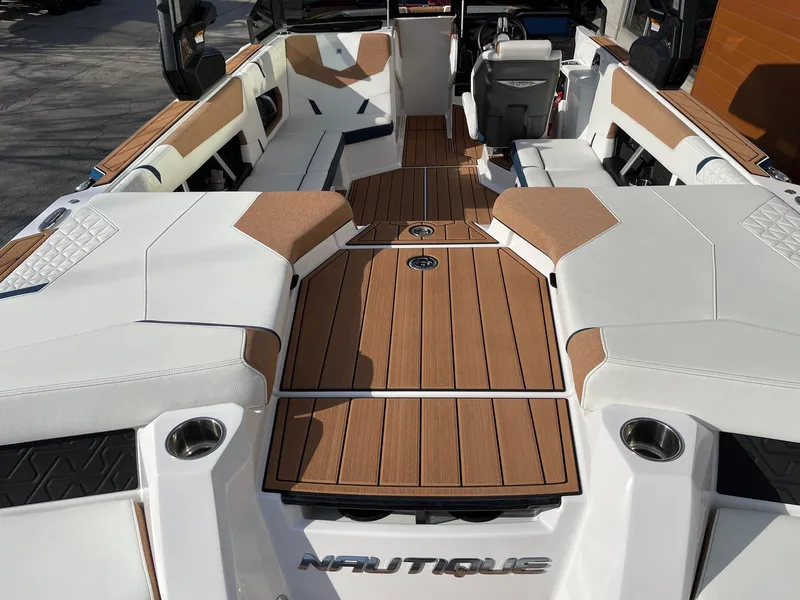 Slide: The Image of 2024 Nautique Super Air Nautique GS22 interior with sleek seating and teak flooring. - 4