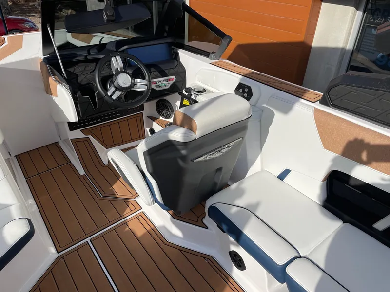Slide: The Image of 2024 Nautique Super Air Nautique GS22 boat interior with modern dashboard and seating. - 6
