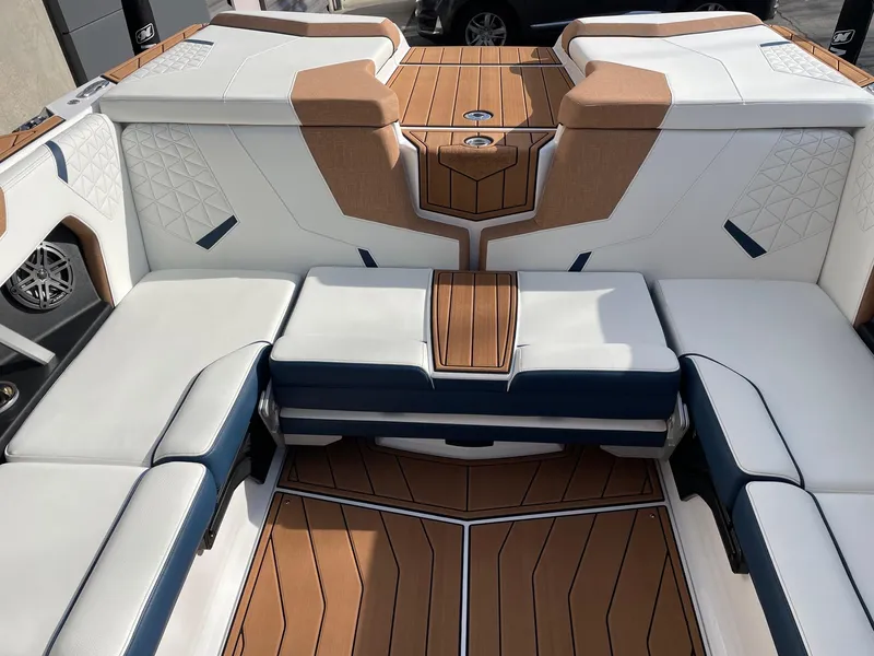 Slide: The Image of 2024 Nautique Super Air Nautique GS22 interior with luxurious seating and teak flooring. - 8