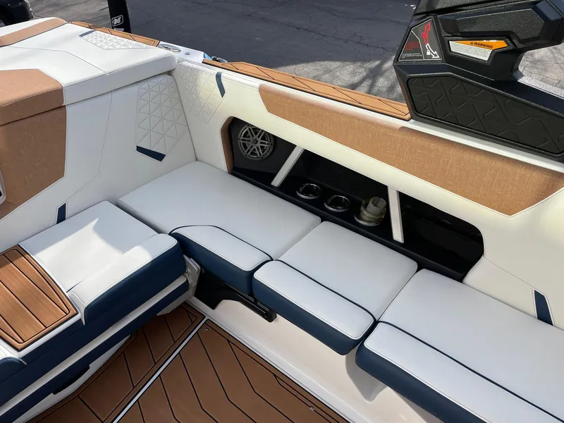 Slide: The Image of 2024 Nautique Super Air Nautique GS22 interior with white and blue seating. - 9