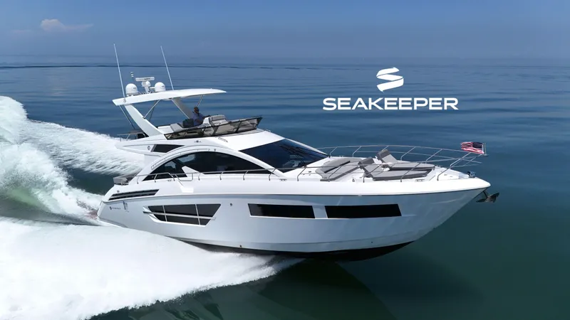 The Image of 2022 Cruisers Yachts 60 Fly cruising on calm waters with Seakeeper logo. - 0