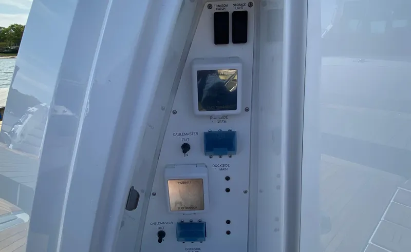 Slide: The Image of Control panel on 2022 Cruisers Yachts 60 Fly, featuring switches and electrical outlets. - 12
