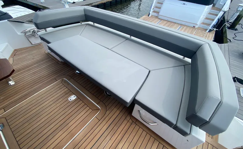 Slide: The Image of Luxurious seating on 2022 Cruisers Yachts 60 Fly, featuring sleek design and teak flooring. - 20