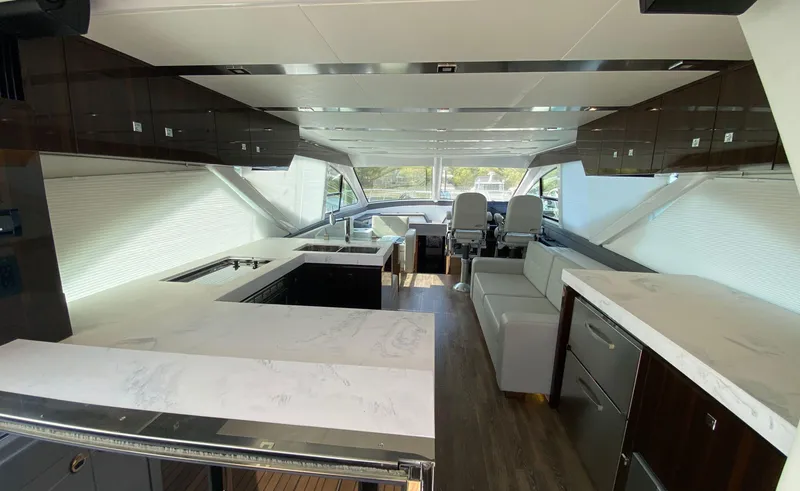 Slide: The Image of Luxurious interior of 2022 Cruisers Yachts 60 Fly with modern kitchen and seating area. - 22