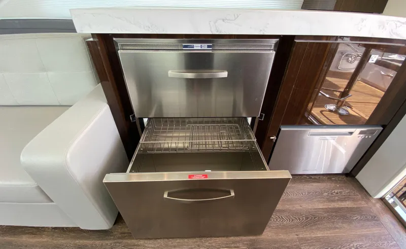 Slide: The Image of Modern kitchen drawers in 2022 Cruisers Yachts 60 Fly, featuring stainless steel design. - 24