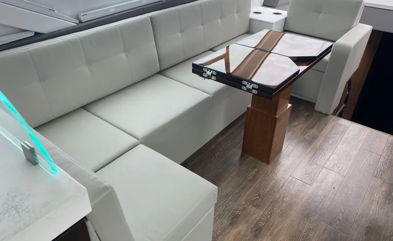 Slide: The Image of Luxurious interior of 2022 Cruisers Yachts 60 Fly with elegant seating and wooden table. - 29