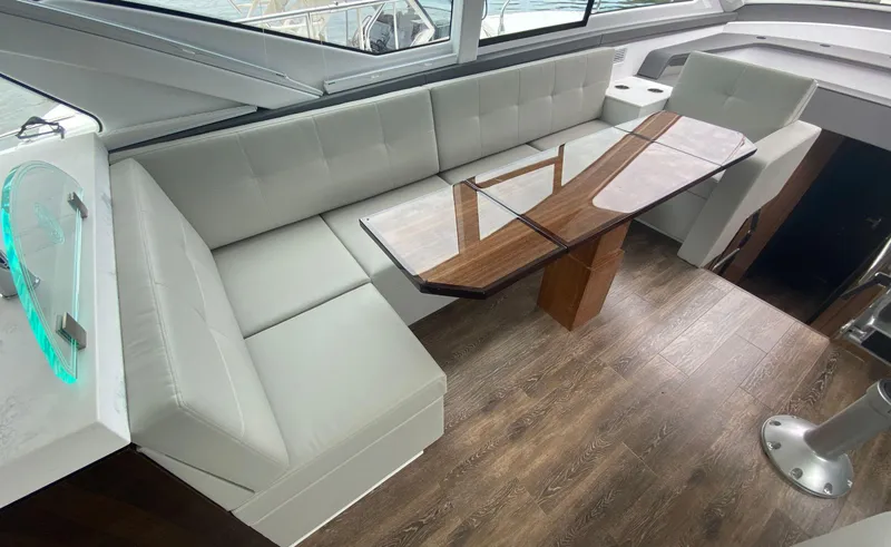 Slide: The Image of Luxurious interior of 2022 Cruisers Yachts 60 Fly with elegant seating and wooden table. - 30
