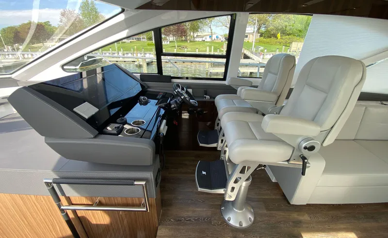 Slide: The Image of Luxurious helm of 2022 Cruisers Yachts 60 Fly with modern seating and controls. - 32