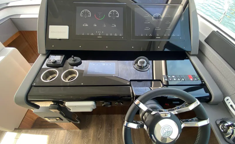 Slide: The Image of Helm of 2022 Cruisers Yachts 60 Fly, featuring modern controls and navigation displays. - 33