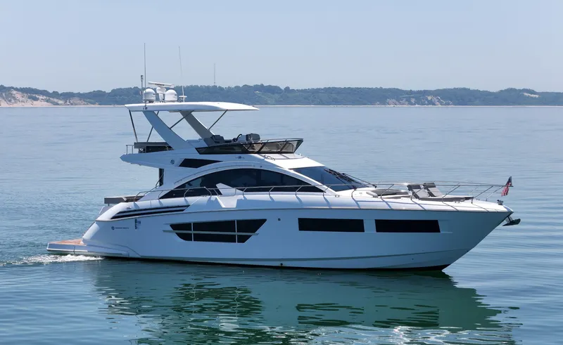 Slide: The Image of Luxury 2022 Cruisers Yachts 60 Fly on calm water, showcasing sleek design and elegance. - 4