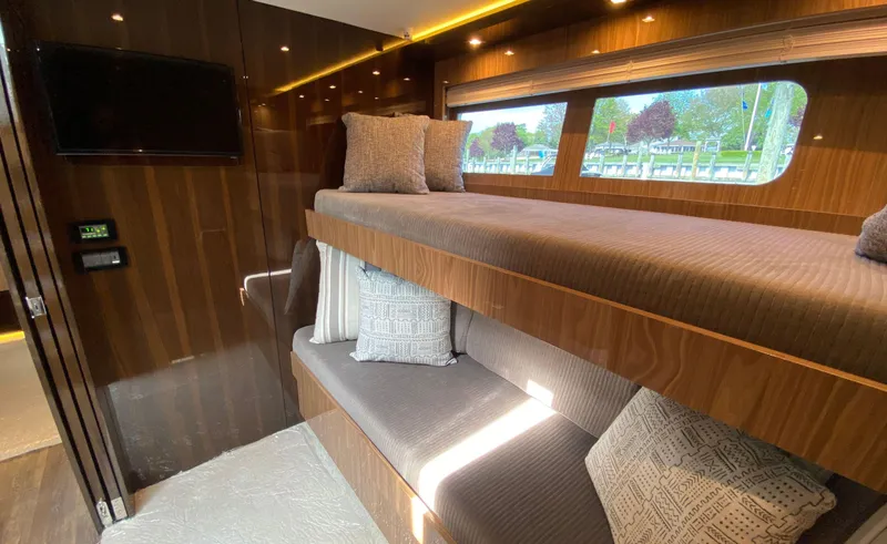 Slide: The Image of Luxurious 2022 Cruisers Yachts 60 Fly cabin with bunk beds and elegant wood finish. - 43