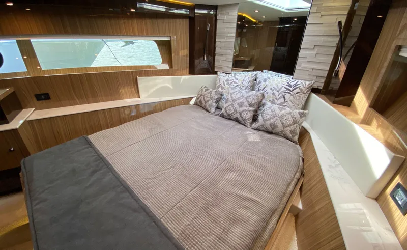 Slide: The Image of Luxurious bedroom interior of 2022 Cruisers Yachts 60 Fly with elegant wood finish. - 45
