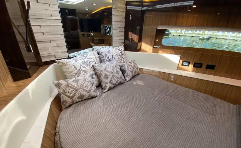 Slide: The Image of Luxurious bedroom interior of 2022 Cruisers Yachts 60 Fly with elegant bedding and window view. - 46