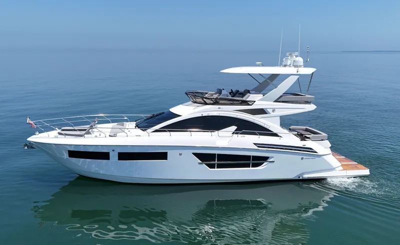 Slide: The Image of 2022 Cruisers Yachts 60 Fly luxury yacht cruising on calm blue waters. - 5