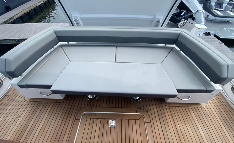 Slide: The Image of Luxurious seating area on 2022 Cruisers Yachts 60 Fly, featuring sleek design and wooden deck. - 19
