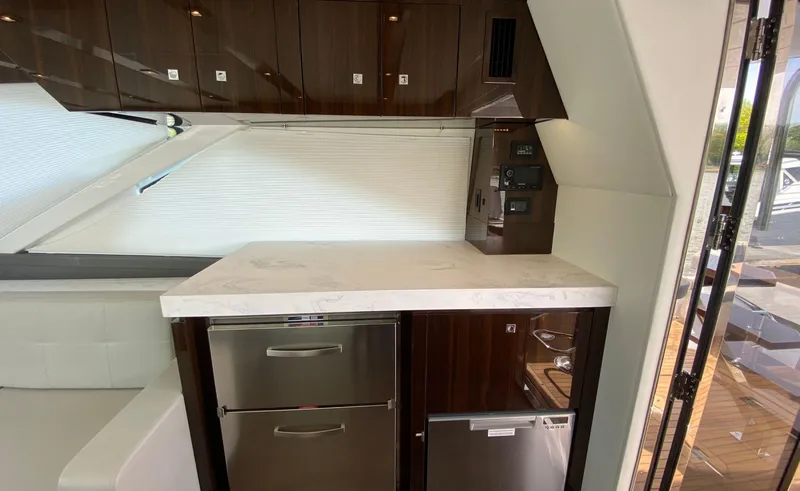 Slide: The Image of Luxurious kitchen area in 2022 Cruisers Yachts 60 Fly with modern appliances and sleek cabinetry. - 23