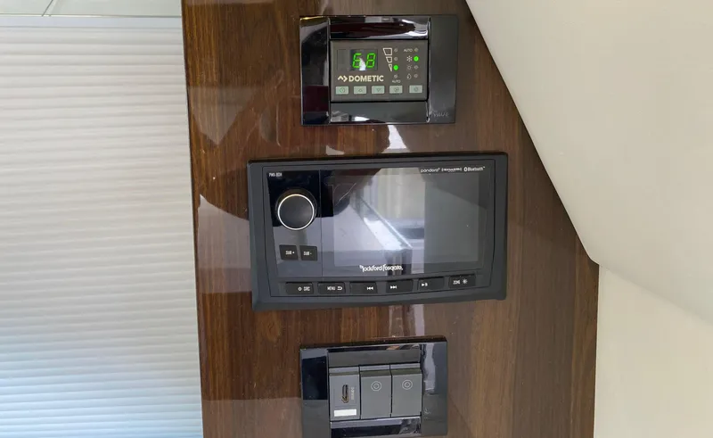 Slide: The Image of Control panel on 2022 Cruisers Yachts 60 Fly, featuring Dometic and Rockford Fosgate systems. - 27