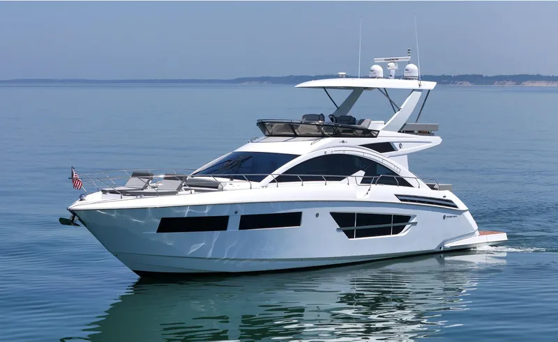 Slide: The Image of 2022 Cruisers Yachts 60 Fly luxury yacht cruising on calm blue waters. - 3