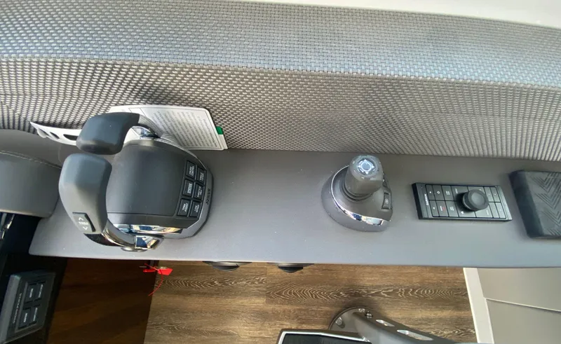 Slide: The Image of Control panel of 2022 Cruisers Yachts 60 Fly, featuring joystick and throttle controls. - 36