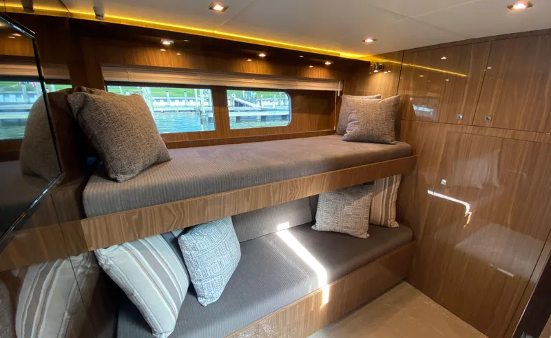Slide: The Image of Luxurious 2022 Cruisers Yachts 60 Fly cabin with wooden interior and cozy bunk beds. - 42