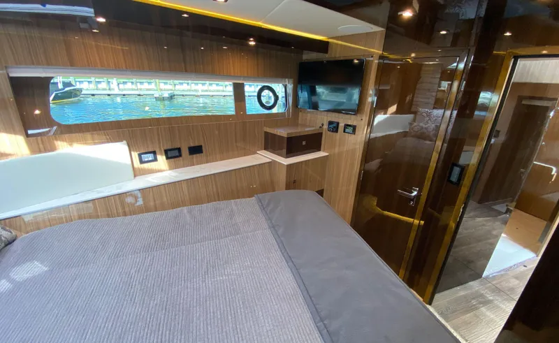 Slide: The Image of Luxurious interior of 2022 Cruisers Yachts 60 Fly with wood paneling and water view. - 47
