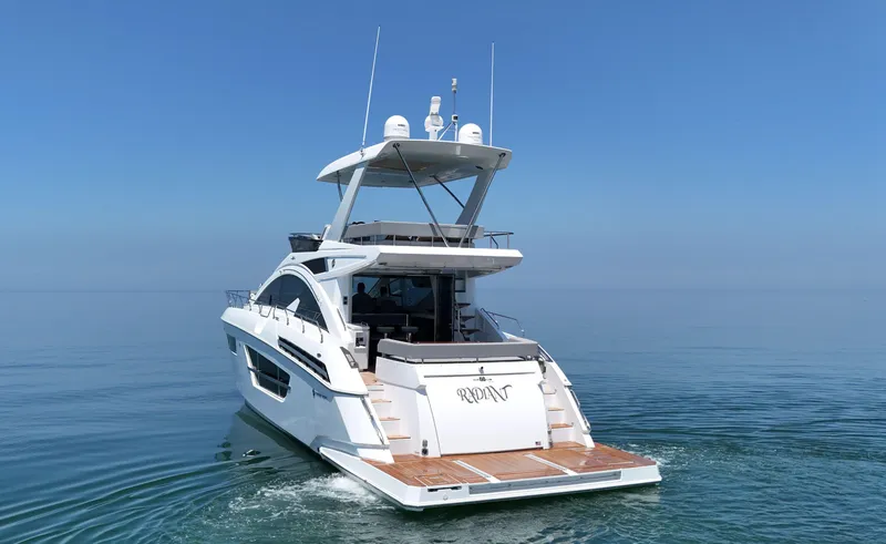 Slide: The Image of 2022 Cruisers Yachts 60 Fly on calm sea, rear view. - 6