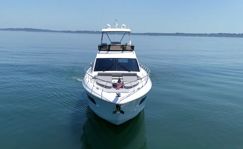 Slide: The Image of 2022 Cruisers Yachts 60 Fly on calm water, front view. - 7