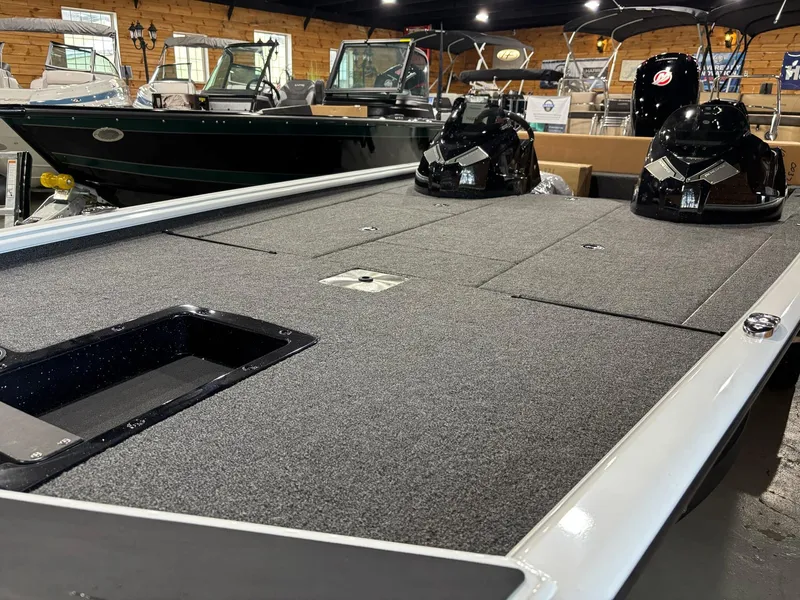 Slide: The Image of 2025 Lund 1975 Renegade SS boat interior with spacious deck in showroom. - 11