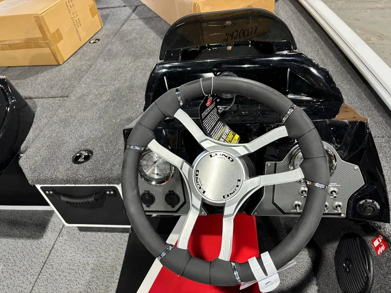 Slide: The Image of Steering wheel of 2025 Lund 1975 Renegade SS boat, featuring modern dashboard design. - 15